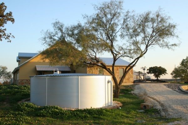 Large Metal Water Tank in Front of a Quaint Country Home
