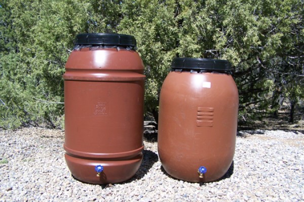 Two Terracotta Rain Barrels Sitting Side By Side in the Sun