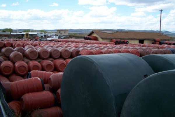 Many Rows of Terracotta Rain Barrels and Green Water Tanks